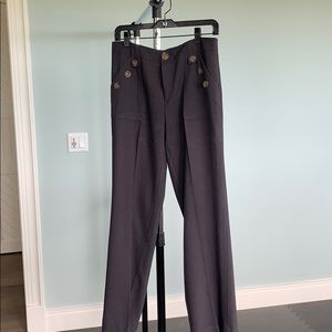 Navy slacks with brown pocket button accent